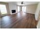 Bright living room features wood-look floors, fireplace, and French doors leading to patio at 302 Silver Fox Trail, Myrtle Beach, SC 29588