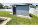 Backyard shed with a dark door, situated on a well-maintained lawn with a walkway at 302 Silver Fox Trail, Myrtle Beach, SC 29588