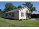 Exterior view of a cozy one-story home with vinyl siding, green shutters, and a well-maintained lawn at 304 S Magnolia Ave., Andrews, SC 29510