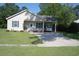 Charming single-story home featuring a well-manicured lawn, carport, and inviting front entrance at 304 S Magnolia Ave., Andrews, SC 29510