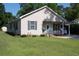 Front view of home showing a lush lawn and inviting entry featuring a carport for covered parking at 304 S Magnolia Ave., Andrews, SC 29510
