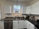Well-lit kitchen featuring stainless steel appliances, granite countertops, and ample white cabinetry at 304 S Magnolia Ave., Andrews, SC 29510