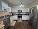 Bright and modern kitchen featuring new stainless steel appliances, and sleek white cabinetry at 304 S Magnolia Ave., Andrews, SC 29510