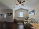 Cozy living room with comfortable seating, vaulted ceiling, and natural light from a bright window at 304 S Magnolia Ave., Andrews, SC 29510
