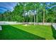 Expansive fenced backyard with a beautiful stone fire pit and lush green lawn at 3129 Slade Dr., Conway, SC 29526