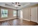 This bedroom boasts hardwood floors, neutral paint, tray ceiling, and two windows at 3129 Slade Dr., Conway, SC 29526