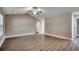 Well-lit living room with vaulted ceiling, wood floors, and neutral paint scheme at 3129 Slade Dr., Conway, SC 29526