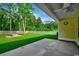 View from the covered patio shows a lush lawn, firepit, and fenced backyard at 3129 Slade Dr., Conway, SC 29526