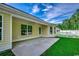 Open patio provides a view of the well-manicured lawn, fenced yard and a treeline at 3129 Slade Dr., Conway, SC 29526