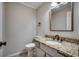 Powder room with granite countertop, framed mirror, and modern fixtures at 3334 Cedar Creek Run, Little River, SC 29566