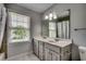 Bathroom featuring a double vanity with modern fixtures and a large window for natural light at 3334 Cedar Creek Run, Little River, SC 29566