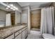 Bathroom featuring granite countertops, tile flooring, and a shower-tub combo at 3334 Cedar Creek Run, Little River, SC 29566