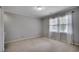 Comfortable bedroom featuring carpet, a large window, and sheer curtains for a bright, airy feel at 3334 Cedar Creek Run, Little River, SC 29566