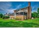 Charming brick home featuring a screened in porch surrounded by a lush green lawn at 3334 Cedar Creek Run, Little River, SC 29566