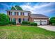 Charming two-story brick home with well-manicured lawn and three car garage at 3334 Cedar Creek Run, Little River, SC 29566
