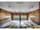 Spacious garage with paneled walls, concrete floor, and two overhead doors allowing plenty of natural light at 3334 Cedar Creek Run, Little River, SC 29566