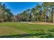 Scenic view of a well-maintained golf course with lush green grass, trees and sand traps on a sunny day at 3334 Cedar Creek Run, Little River, SC 29566