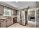 Updated kitchen featuring stainless steel appliances, granite countertops, and adjacent laundry area at 3334 Cedar Creek Run, Little River, SC 29566