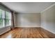 Bright living room with hardwood floors, large windows, and neutral paint at 3334 Cedar Creek Run, Little River, SC 29566