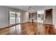 Open-concept living room with hardwood floors and sliding glass door leading to screened-in porch at 3334 Cedar Creek Run, Little River, SC 29566