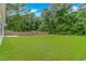 Expansive green backyard with lush grass, trees, and privacy fence at 3539 Harrelson Ave., Loris, SC 29569