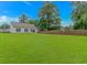 Large, lush backyard with healthy green grass and privacy fence at 3539 Harrelson Ave., Loris, SC 29569