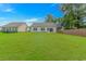 Spacious backyard with a green lawn, privacy fence, and back of home at 3539 Harrelson Ave., Loris, SC 29569