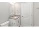 Bathroom with granite countertop, single sink, framed mirror, and white door at 3539 Harrelson Ave., Loris, SC 29569