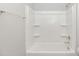 Clean white bathtub and shower combination with shelving and chrome fixtures at 3539 Harrelson Ave., Loris, SC 29569