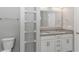 Bathroom featuring a double sink vanity, granite counters, and custom shelving for storage at 3539 Harrelson Ave., Loris, SC 29569