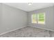 Empty bedroom with neutral walls, carpeting, and window with blinds at 3539 Harrelson Ave., Loris, SC 29569