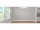 Light-filled dining room featuring a modern chandelier and view to the kitchen at 3539 Harrelson Ave., Loris, SC 29569