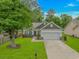 Charming single-story home boasts a two-car garage, a well-manicured lawn, and lovely landscaping at 3539 Harrelson Ave., Loris, SC 29569
