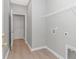 Laundry room with white walls, wood-look flooring, and wire shelving at 3539 Harrelson Ave., Loris, SC 29569