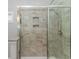 Elegant tiled shower with glass enclosure and built-in shelving for toiletries storage at 3539 Harrelson Ave., Loris, SC 29569
