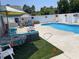 Enjoy outdoor living with a well-appointed backyard patio, complete with seating, turf, and a private pool area at 4013 Blackwolf Dr., Myrtle Beach, SC 29579