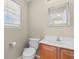Bathroom with a light wood vanity, a square mirror, and a toilet next to the window at 4013 Blackwolf Dr., Myrtle Beach, SC 29579