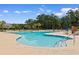 The beautiful community pool is surrounded by ample seating and mature trees, perfect for relaxation and recreation at 4013 Blackwolf Dr., Myrtle Beach, SC 29579