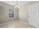 Cozy dining area with tile flooring, a window for natural light, and a classic chandelier at 4013 Blackwolf Dr., Myrtle Beach, SC 29579