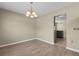 The dining room features wood flooring, a chandelier, and fresh paint with an easy flow to the kitchen at 4013 Blackwolf Dr., Myrtle Beach, SC 29579