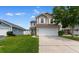 Charming two-story home featuring a spacious front yard, two-car garage, and neutral siding, all under a sunny sky at 4013 Blackwolf Dr., Myrtle Beach, SC 29579