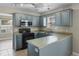 The U-shaped kitchen offers ample counter space, blue cabinets, modern appliances, and natural light at 4013 Blackwolf Dr., Myrtle Beach, SC 29579
