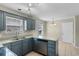 The U-shaped kitchen offers ample counter space, blue cabinets, modern appliances, and natural light at 4013 Blackwolf Dr., Myrtle Beach, SC 29579