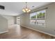 A bright living room features wood flooring, large windows, sliding doors, and fresh paint ready for personalization at 4013 Blackwolf Dr., Myrtle Beach, SC 29579