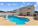 Backyard view of this home, showcasing a refreshing private pool and poolside lounging space on a sunny day at 4013 Blackwolf Dr., Myrtle Beach, SC 29579