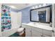 Bathroom showcasing a tub and shower with a blue shower curtain, toilet, and white vanity at 4103 N Ocean Blvd. N # 204, North Myrtle Beach, SC 29582