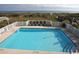 Outdoor pool with lounge chairs and beach access in the background of the shot at 4103 N Ocean Blvd. N # 204, North Myrtle Beach, SC 29582