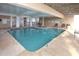 Indoor pool area with a large pool and an adjacent spa pool and multiple lounge chairs at 4103 N Ocean Blvd. N # 204, North Myrtle Beach, SC 29582