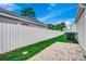 Fenced backyard offers privacy with a small paver patio area and green grass at 422 South Poplar Dr., Surfside Beach, SC 29575