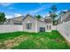 Well-maintained backyard featuring a privacy fence, green lawn, and access to the home at 422 South Poplar Dr., Surfside Beach, SC 29575